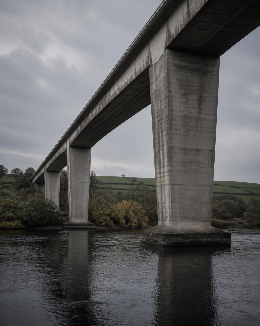 Concrete highway structure crossing a river in the UK countryside